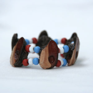 Elastic, double-stranded bracelet with white red and blue beads